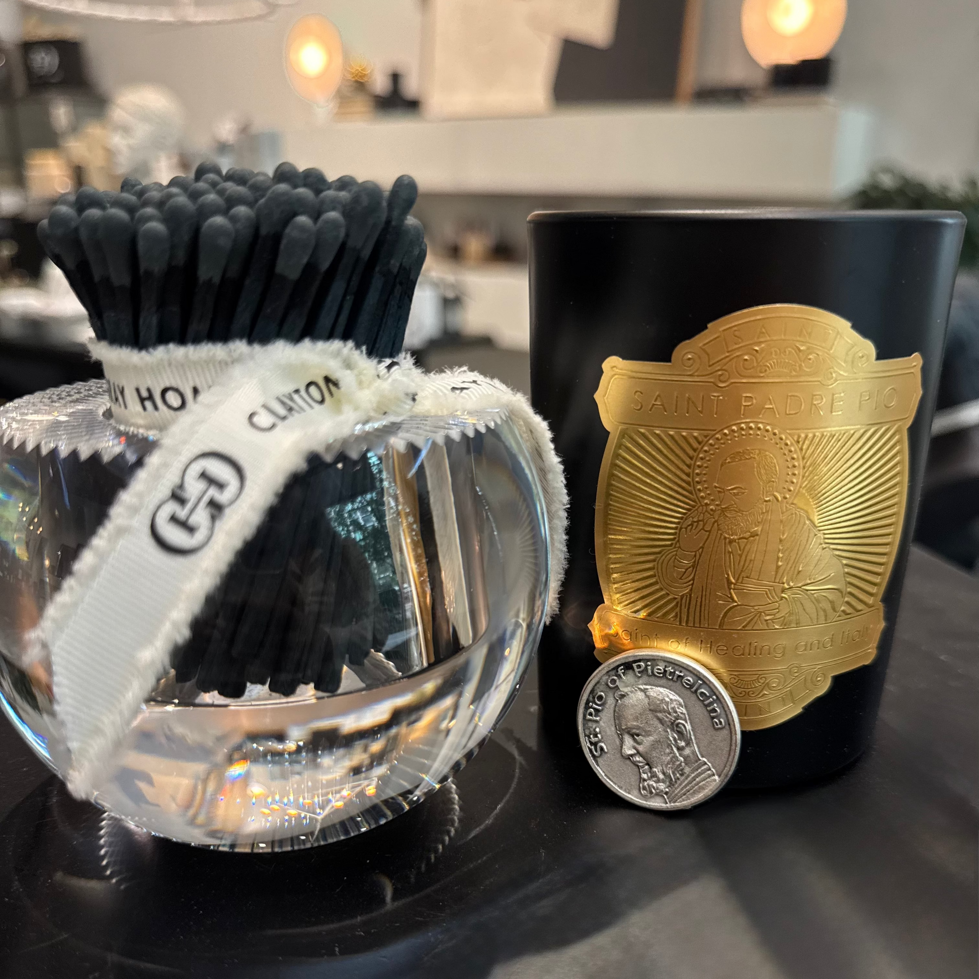 Bathroom setting with a brush holder, brush, and decorative candle.