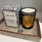 Candle with decorative packaging on a textured surface