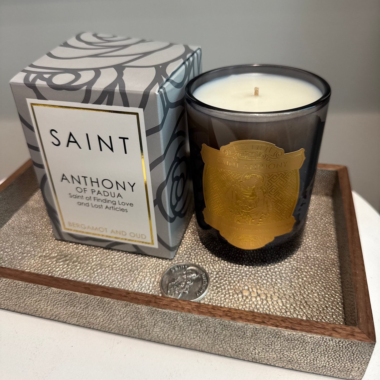 Candle with decorative packaging on a textured surface