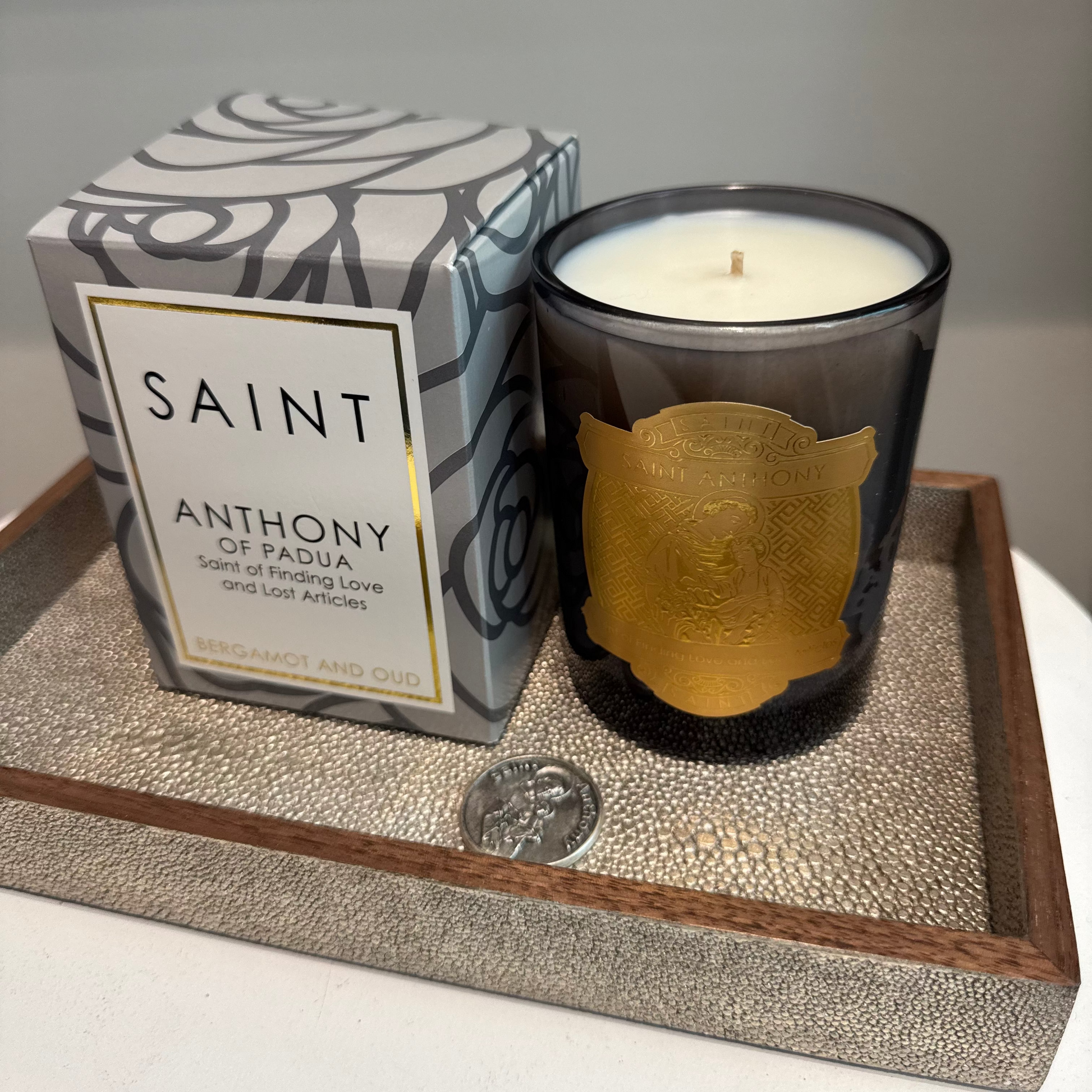 Candle with decorative packaging on a textured surface