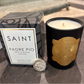 Candle with gold emblem and packaging labeled 'Saint Padre Pio' on a stone surface.