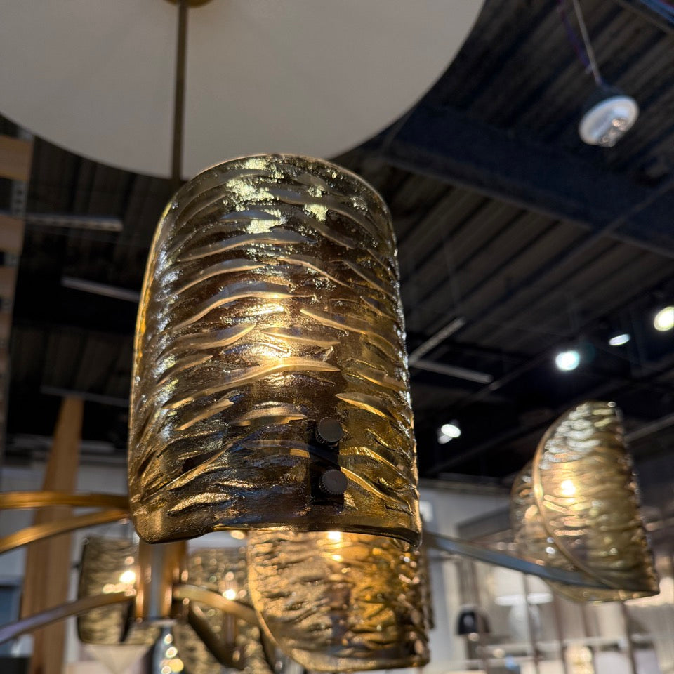 Gold textured pendant light fixture in a showroom setting