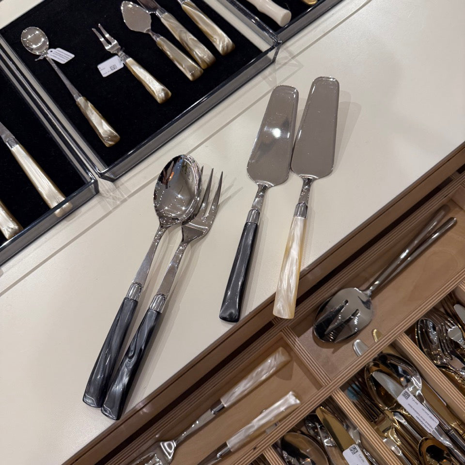 Collection of silverware including forks, spoons, and knives in a drawer.