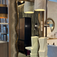 Decorative mirror with wavy frame in a showroom setting