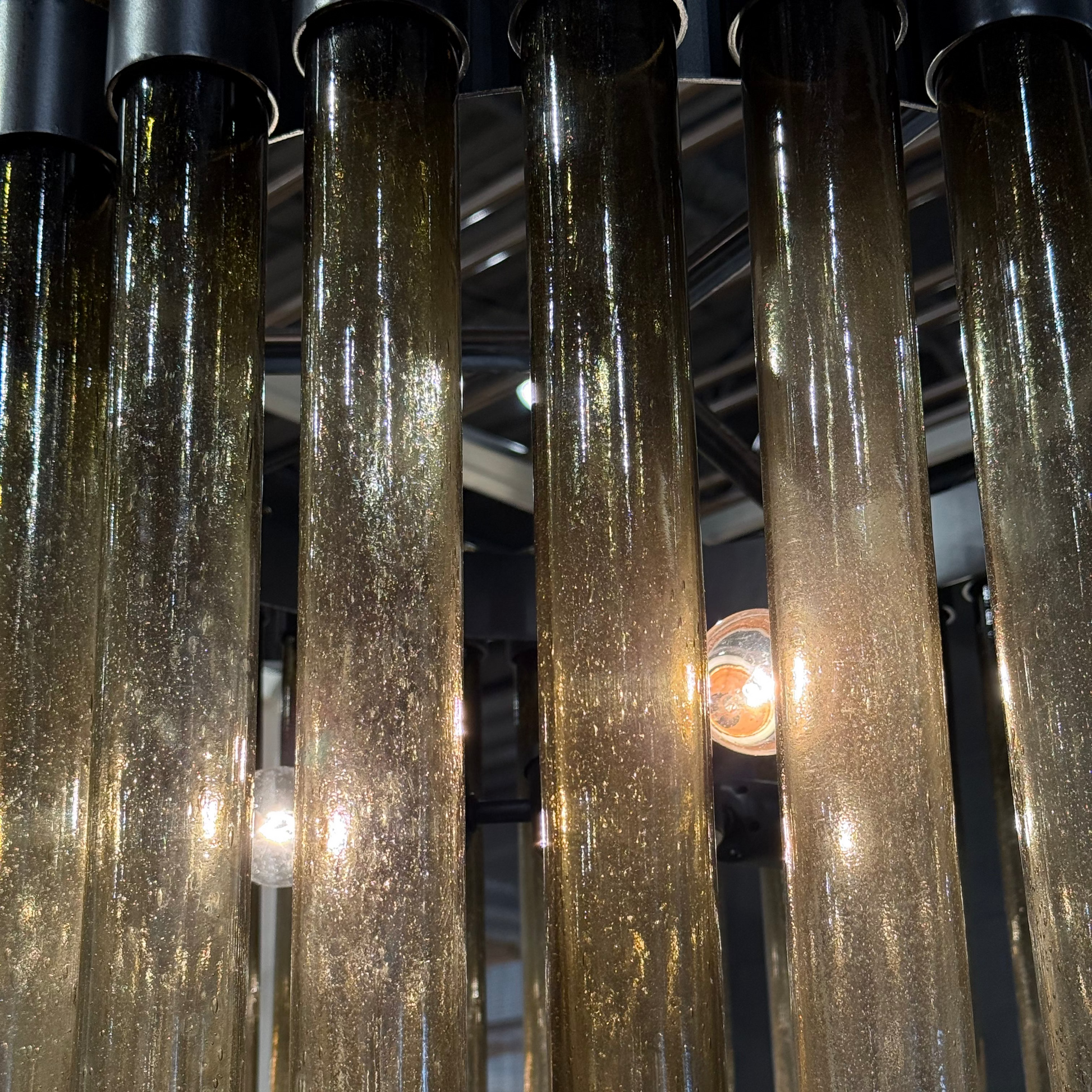 Close-up of textured glass tubes with light reflections