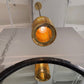 Gold pendant light fixture hanging from a ceiling