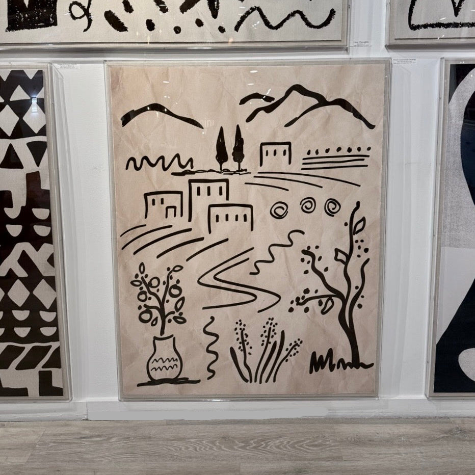 Decorative wall art with black line drawings on a beige background, displayed among other artworks.