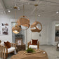 Modern living room with wooden furniture and pendant lights in a showroom setting.