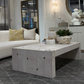 Modern living room with a white sofa, marble coffee table, and decorative elements.