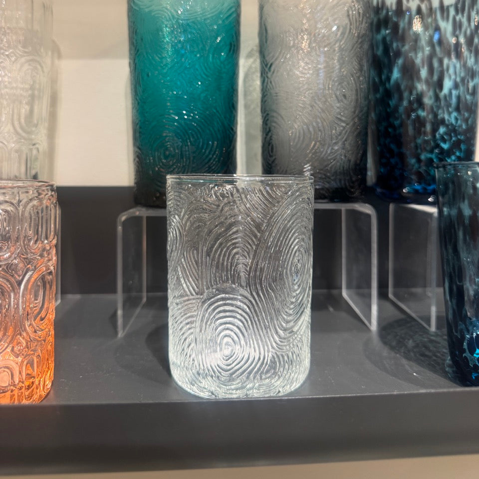 Collection of textured glass vases on a shelf