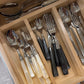 Set of silverware in a wooden drawer organizer