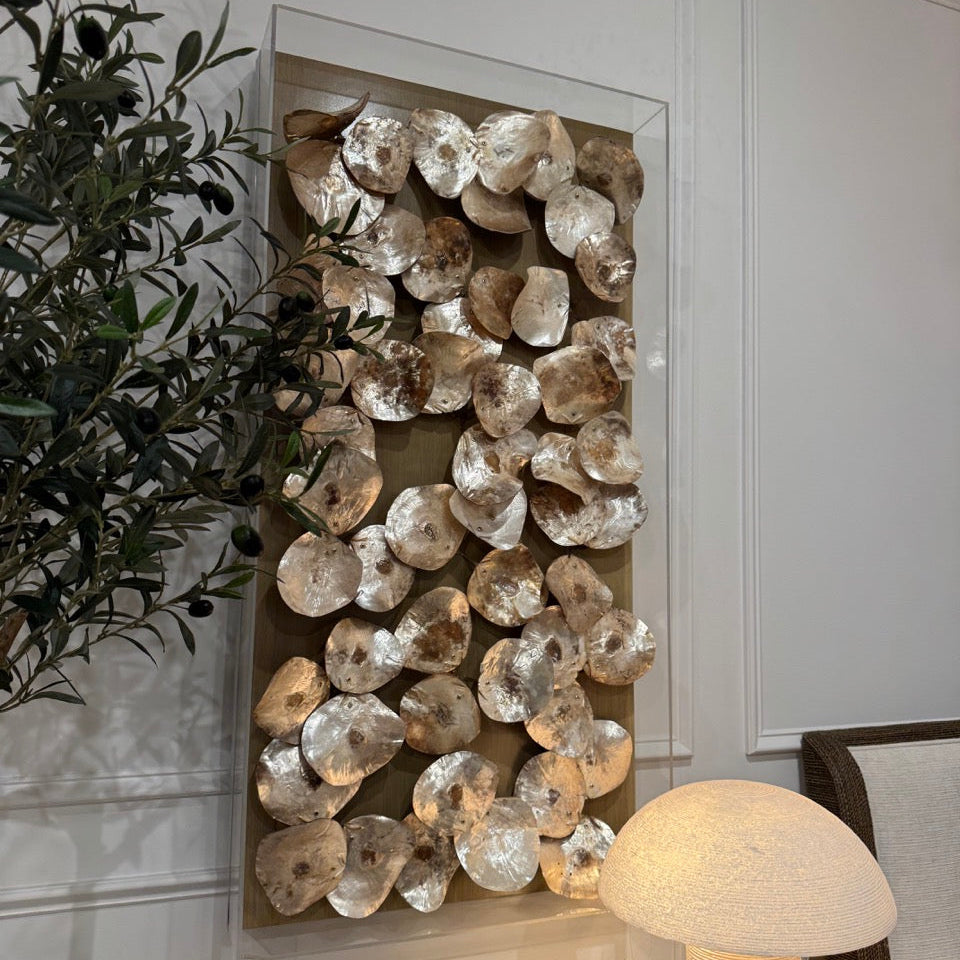 Decorative wall art with stacked stones in a room setting