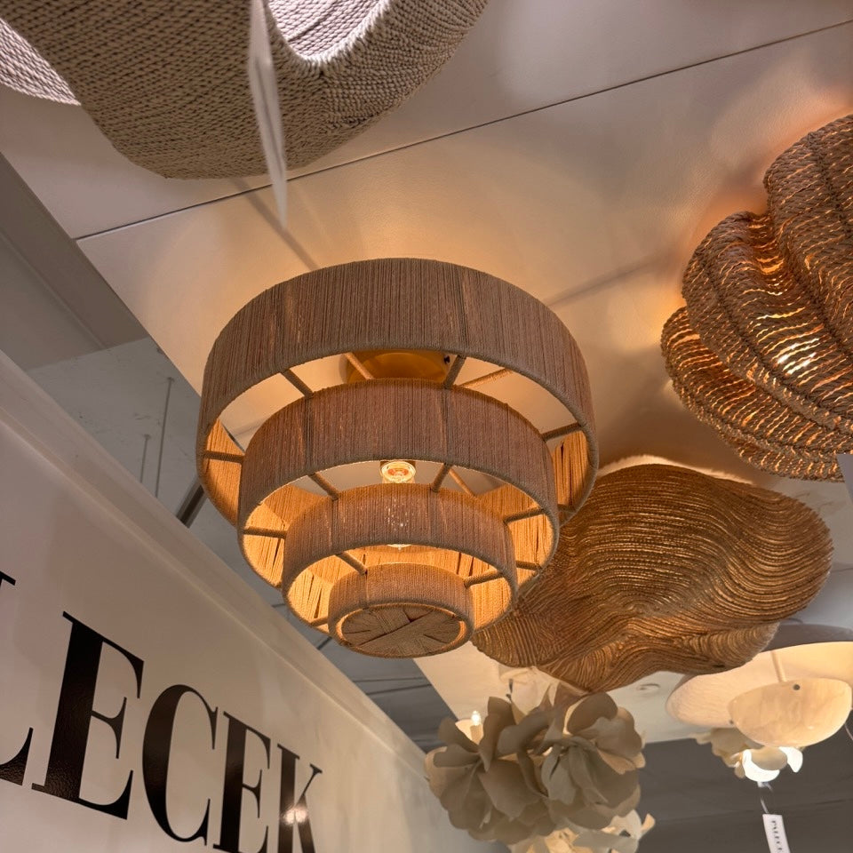 Chandelier with woven design hanging in a showroom with 'LECEK LIGHTING' branding.
