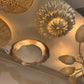 Gold ceiling lights with intricate designs on a ceiling