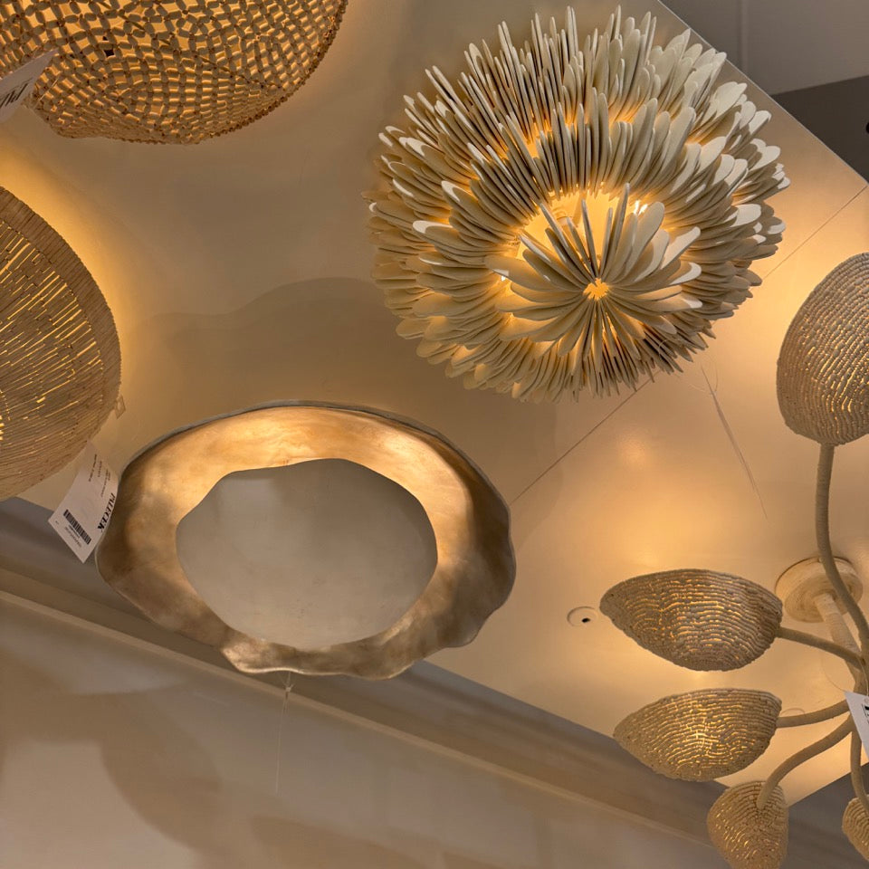 Gold ceiling lights with intricate designs on a ceiling