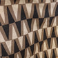Patterned fabric on a rack with fabrics in the background