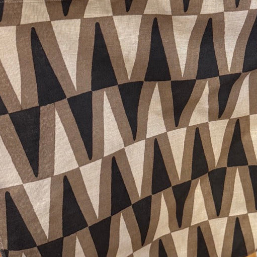Patterned fabric on a rack with fabrics in the background