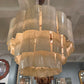 Large chandelier hanging in a room with mirrors and decor