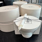 Set of white gift boxes with a candle on a dark surface