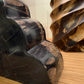 Close-up of large metal gears on a wooden surface