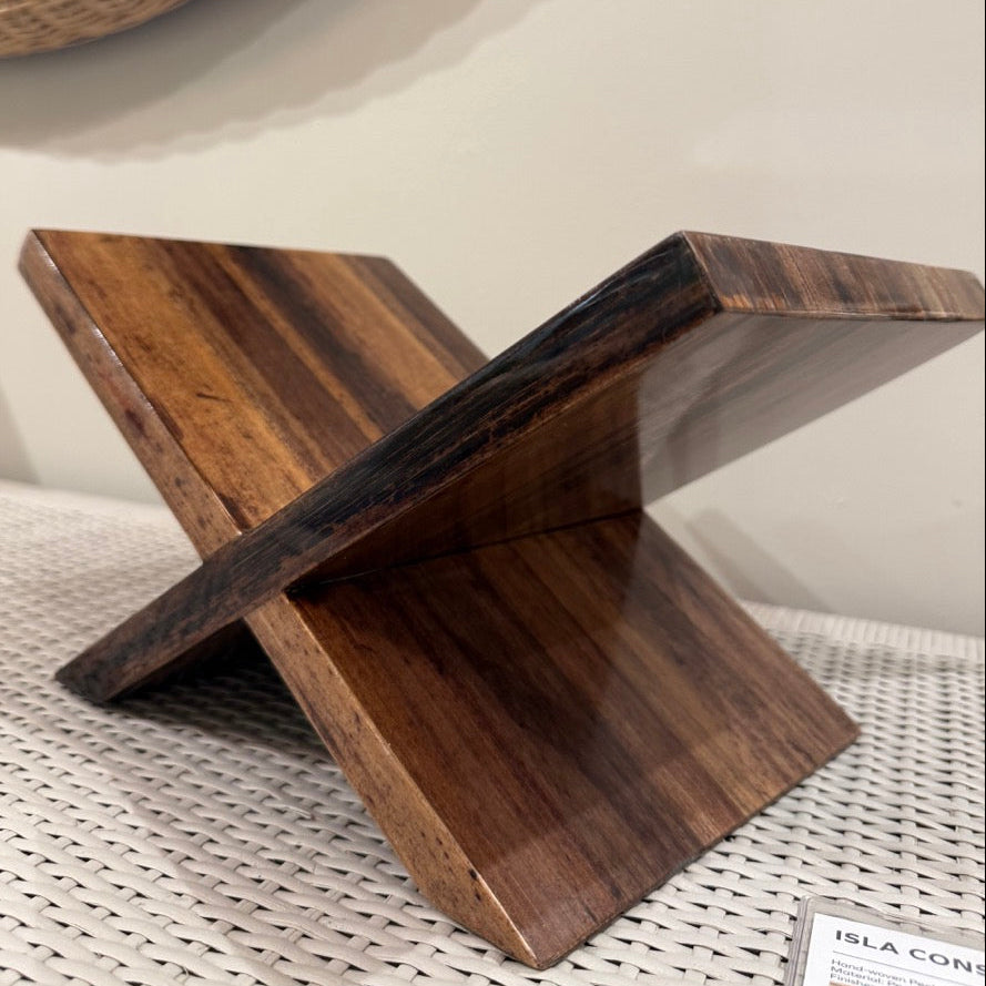 Wooden stool with a natural finish on a textured surface