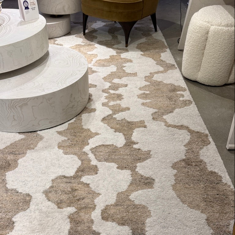 Patterned rug on a floor with furniture in the background