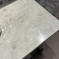 Close-up of a marble countertop with a blurred background