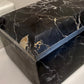 Black marble coffee table on a white surface
