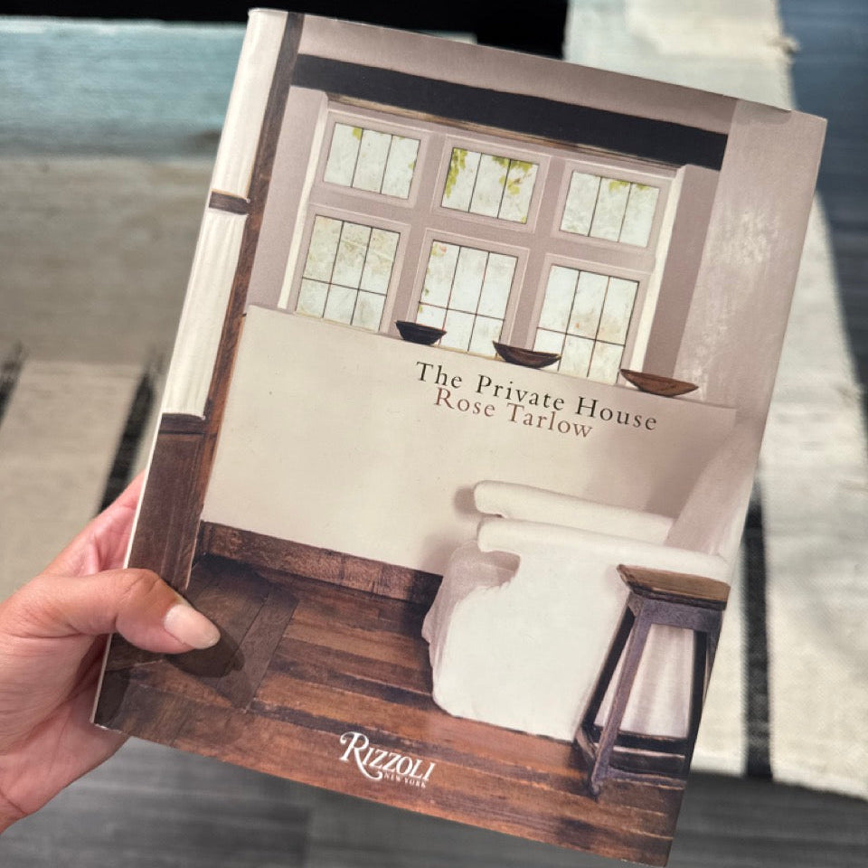 Book titled 'The Private House' by Rose Tarlow held in a hand with a blurred indoor background.