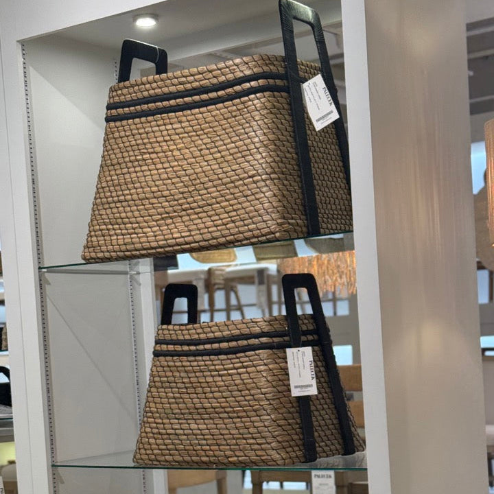 Wicker baskets displayed in a store setting with labels.