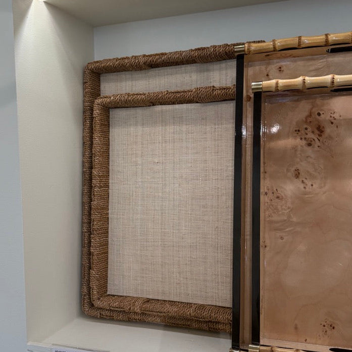 Display of framed wall art with various designs on a white wall.