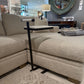 Beige sectional sofa with a small table in a room setting
