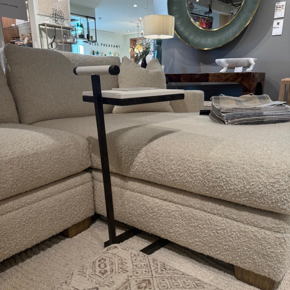 Beige sectional sofa with a small table in a room setting