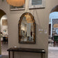 Futuristic interior design with a large mirror and modern decor elements.