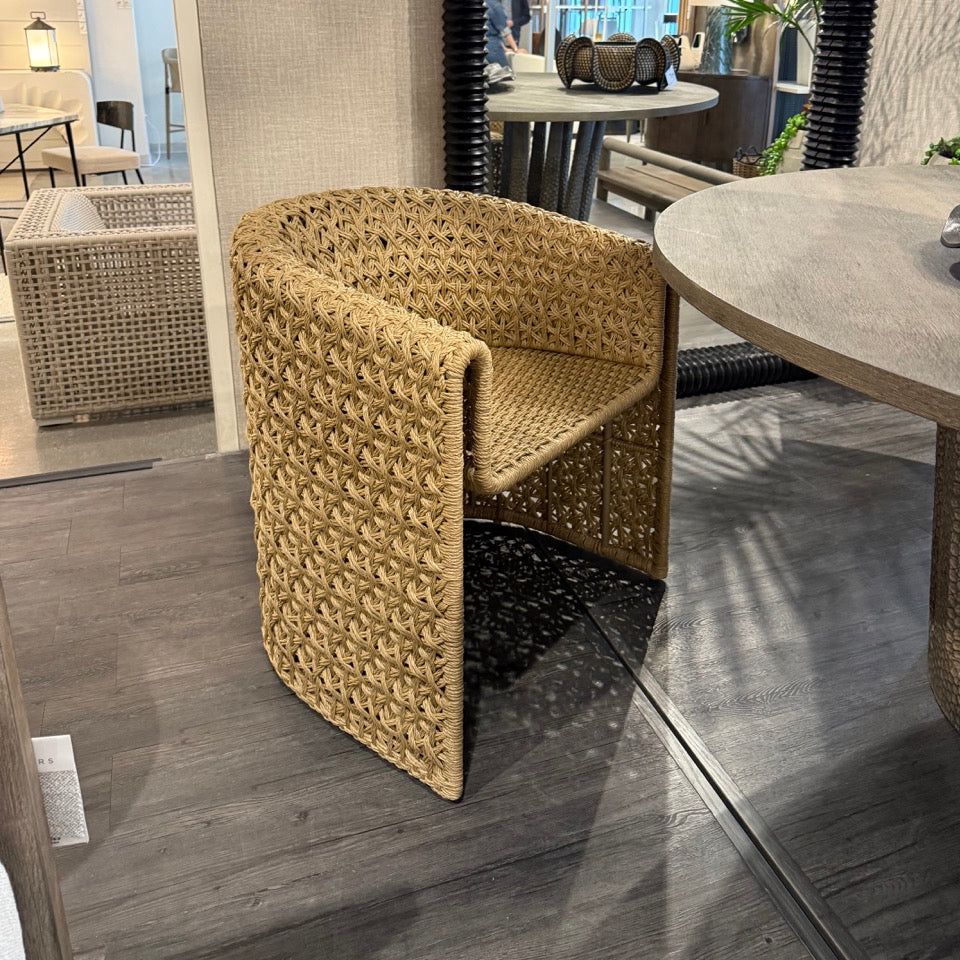 Woven chair in a showroom setting with tables and decor