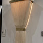 Wall-mounted light fixture with woven design on a white wall