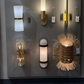 Collection of various wall sconces on a gray wall