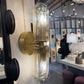 Wall-mounted light fixture with glass shade in a store setting