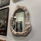Decorative mirrors with unique frames on a wall