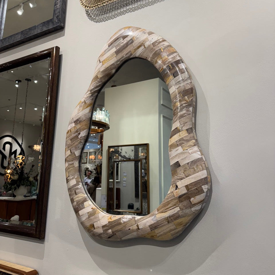 Decorative mirrors with unique frames on a wall