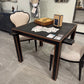 Dining table with playing cards and a box on a tiled floor