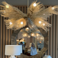 Decorative chandelier with lights above a mirror and lamps.