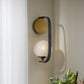 Wall-mounted light fixture with a floral arrangement in the foreground