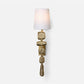 Decorative wall sconce with textured gold base and white shade on a light gray background