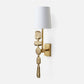 Decorative wall sconce with textured gold base and white shade on a light gray background
