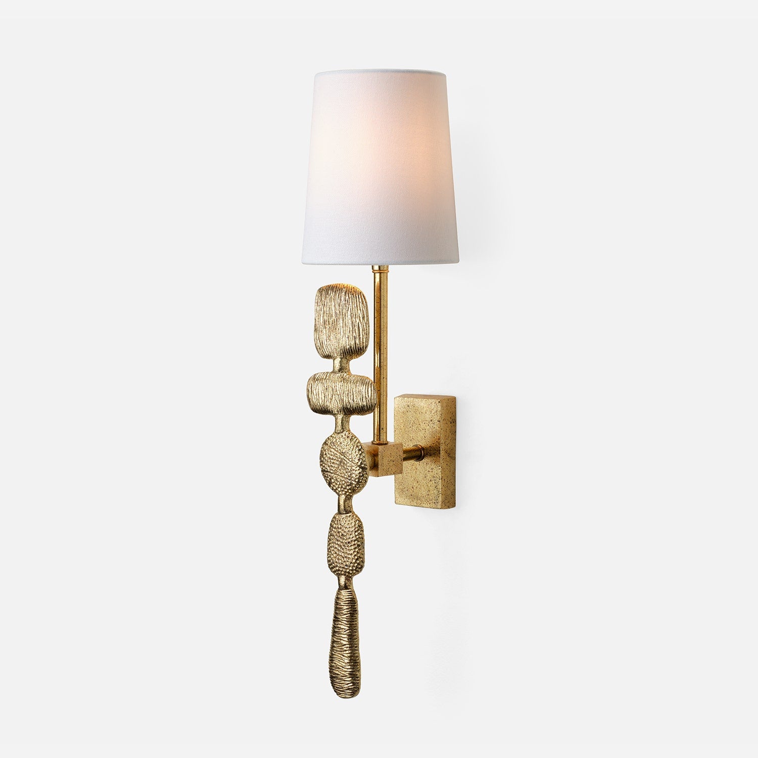 Decorative wall sconce with textured gold base and white shade on a light gray background