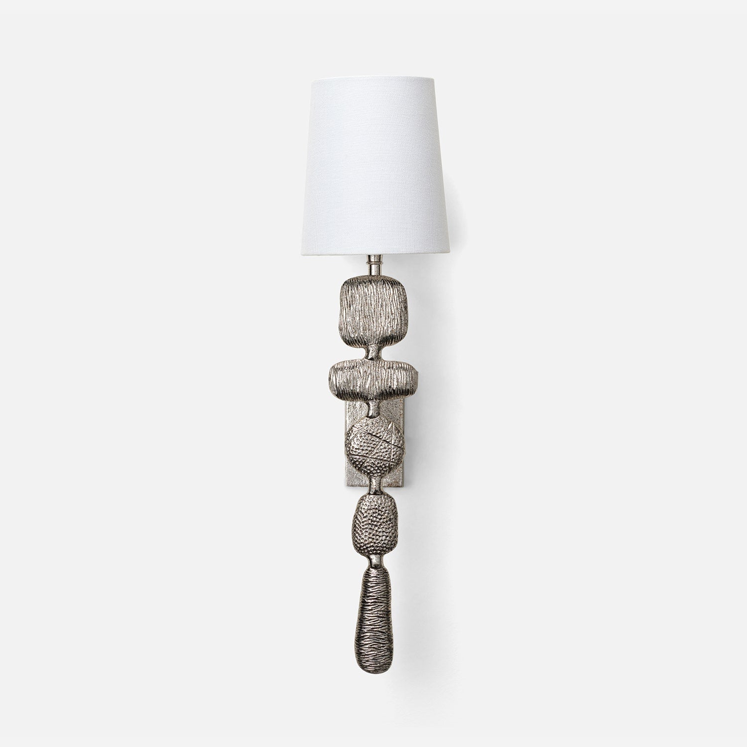 Decorative wall sconce with textured design and white shade on a light gray background