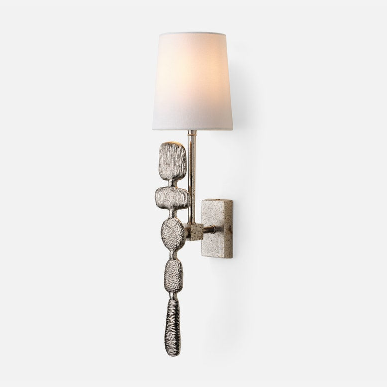 Decorative wall sconce with textured design on a white background