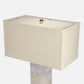Beige table lamp with a rectangular shade on a white background
