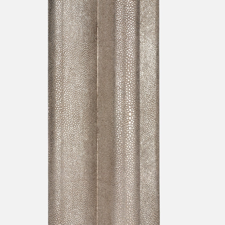 Textured neutral table lamp with a sculptural fluted base on a white background.